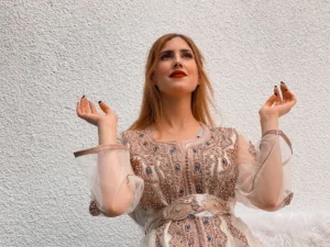 a woman in a dress holding a cigarette
