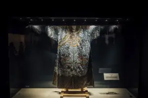 A mannequin is displayed in a dark room