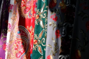Colorful textiles with intricate patterns displayed in a row.