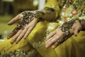 Pakistani indian Mendhi night. Bride to be with yellow dress and mendhi.